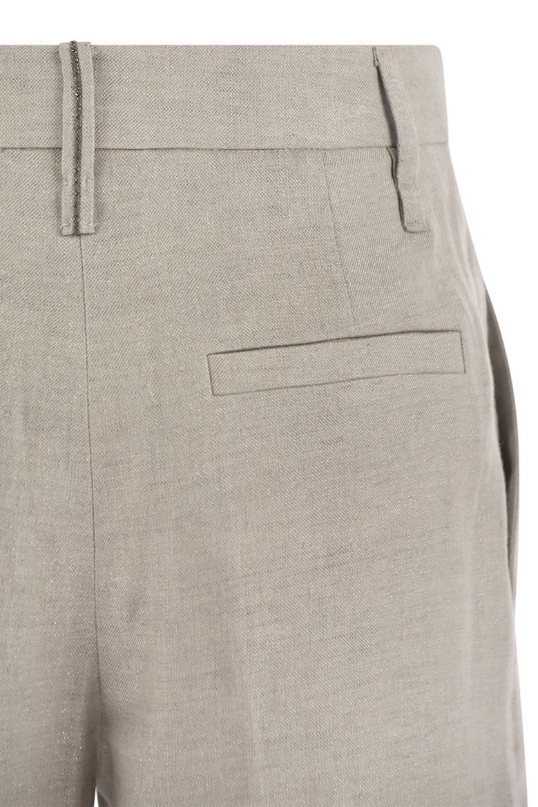 flared loose-fitting trousers in sparkling linen twill with necklace by Selfnex