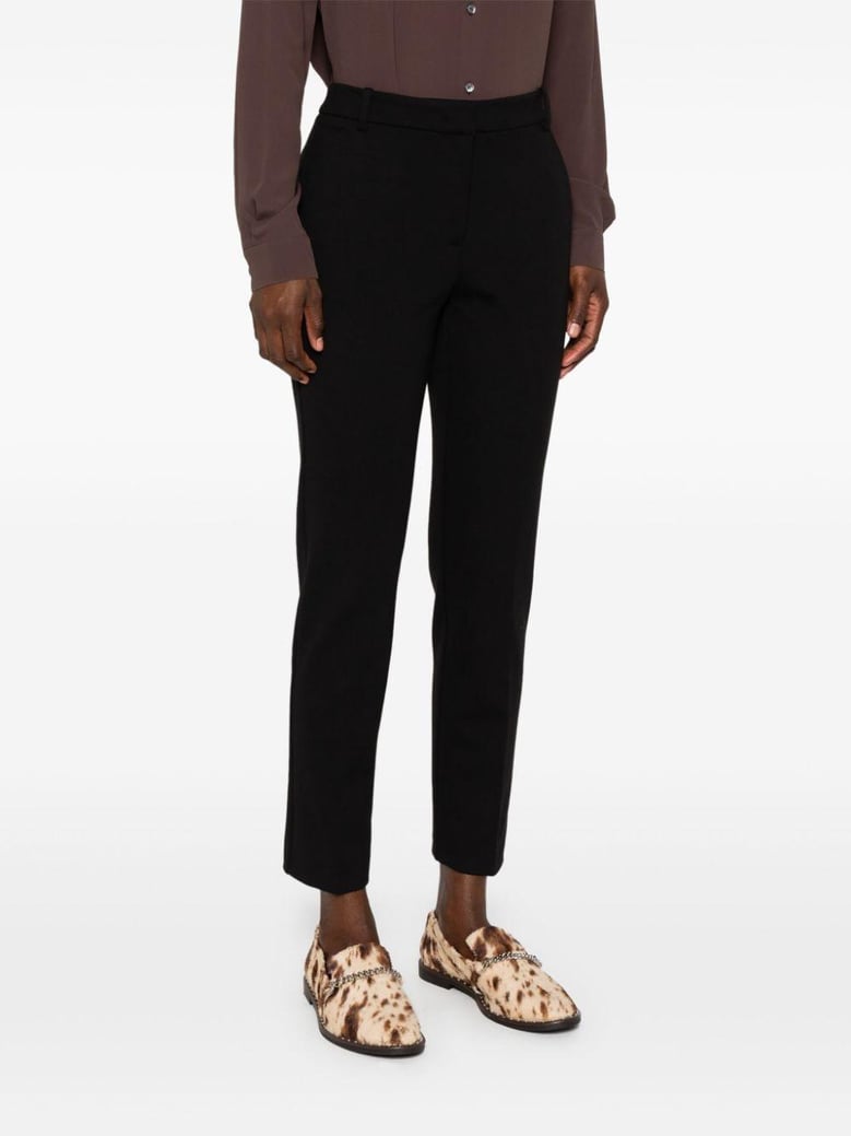 black milano-knit slim trousers by Selfnex