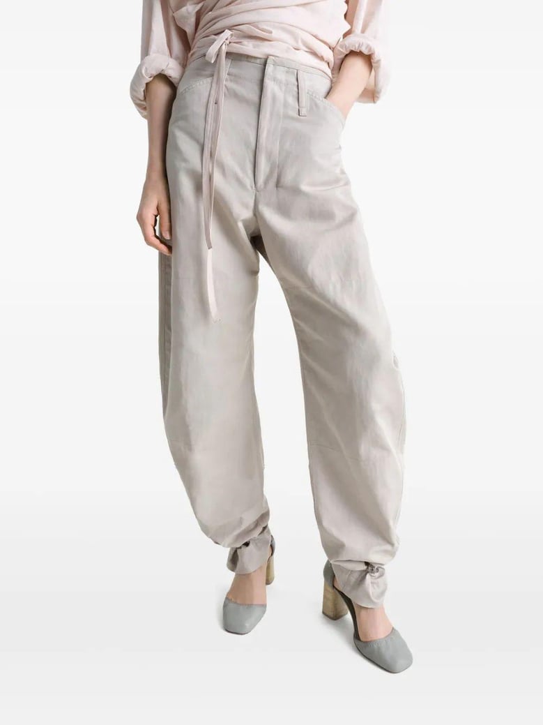 beige tapered pants with camal buttons by Selfnex