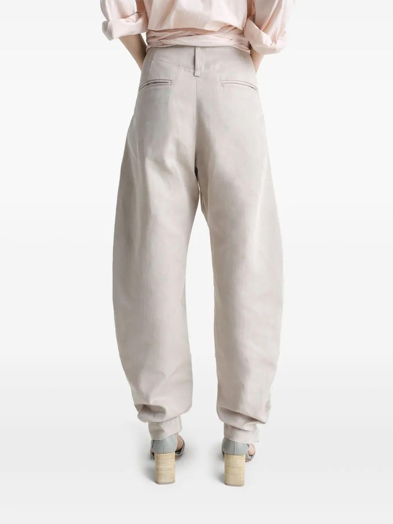 beige tapered pants with camal buttons by Selfnex
