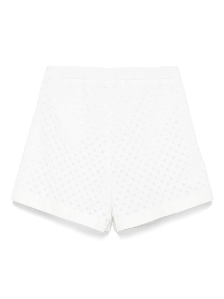 perforated shorts with geometric shapes by Selfnex