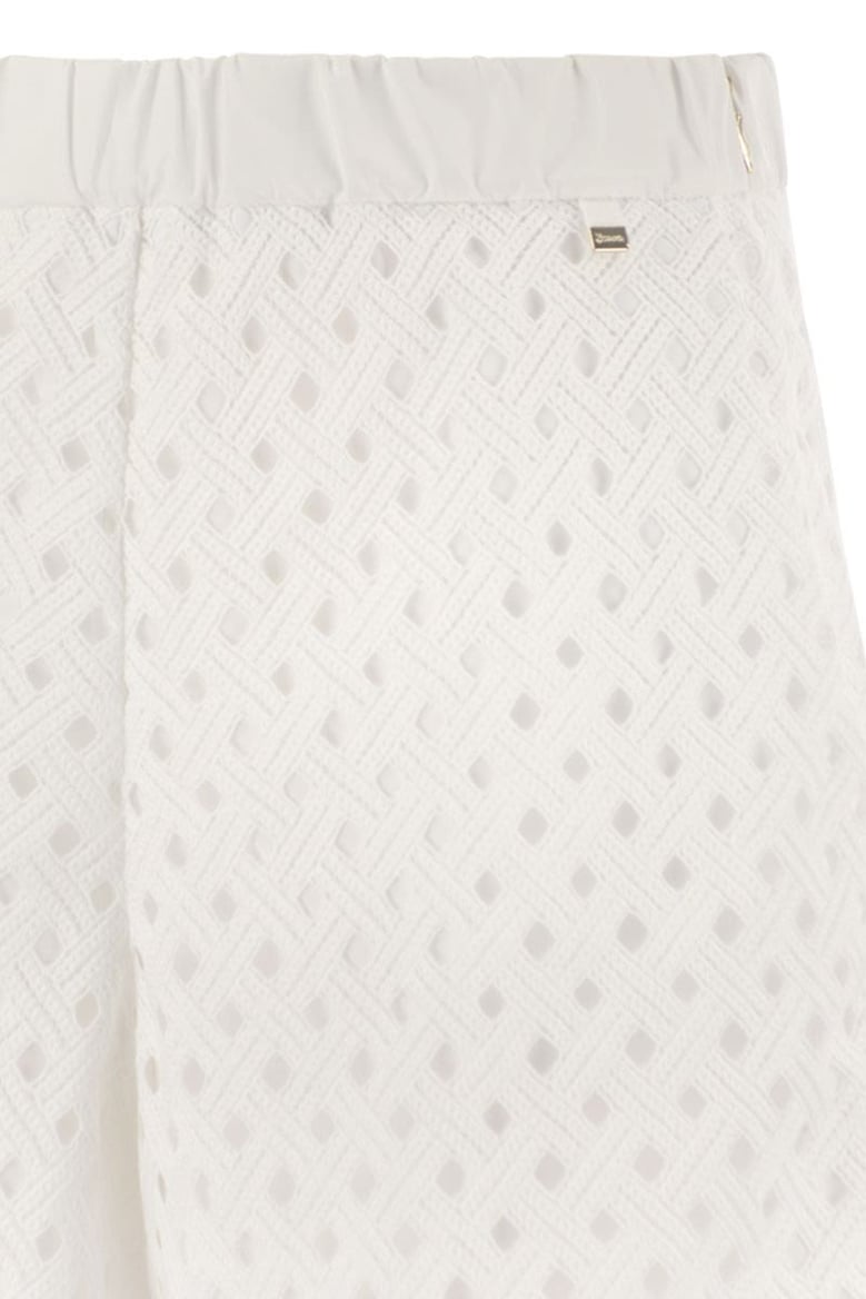 perforated shorts with geometric shapes by Selfnex