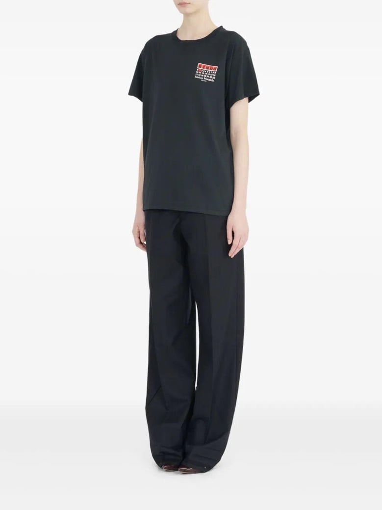 maison margiela blingo short-sleeved black cotton t-shirt graphic on the front four-stitch detail on the back by Selfnex