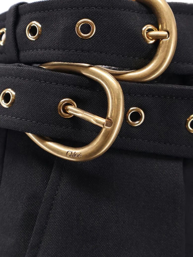 black trousers with double belt and gold buckles by Selfnex