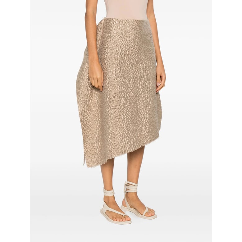 beige textured finish skirt with asymmetric hem by Selfnex