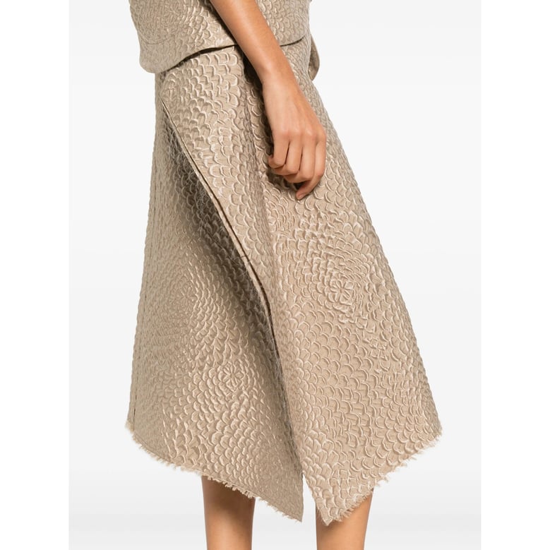 beige textured finish skirt with asymmetric hem by Selfnex