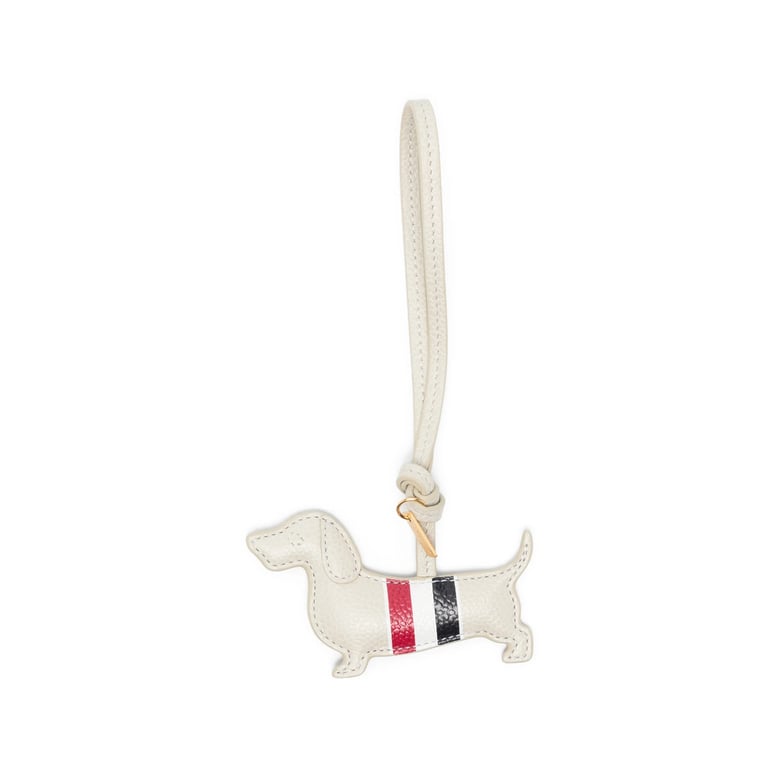 beige dog-shaped keyring with gold-tone hardware by Selfnex
