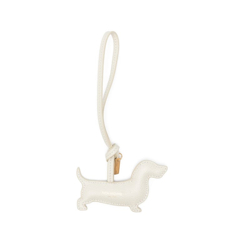 beige dog-shaped keyring with gold-tone hardware by Selfnex