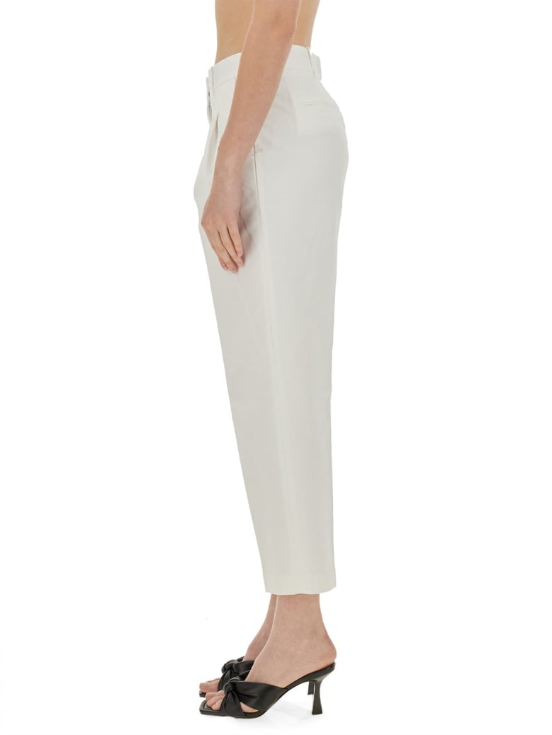 cropped pants in white by Selfnex