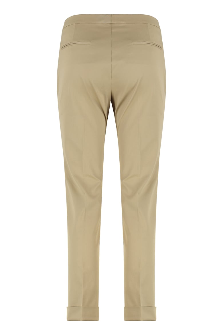 beige cropped trousers by Selfnex