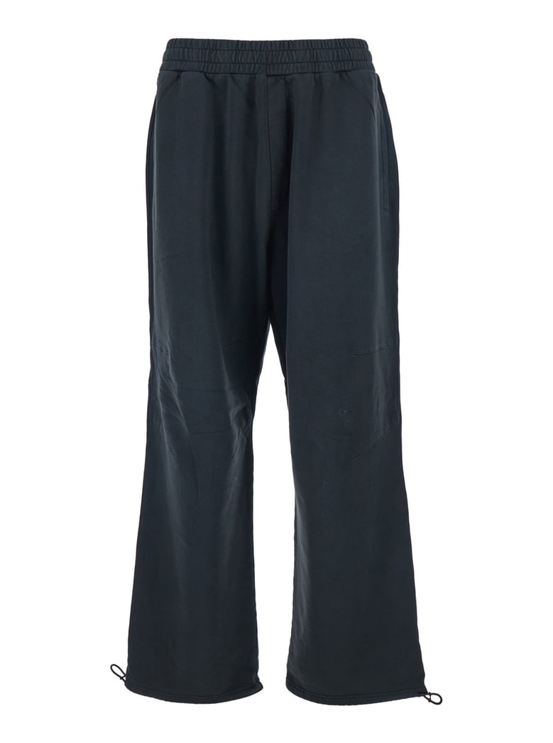black pants with elastic waist and drawstring hem by Selfnex