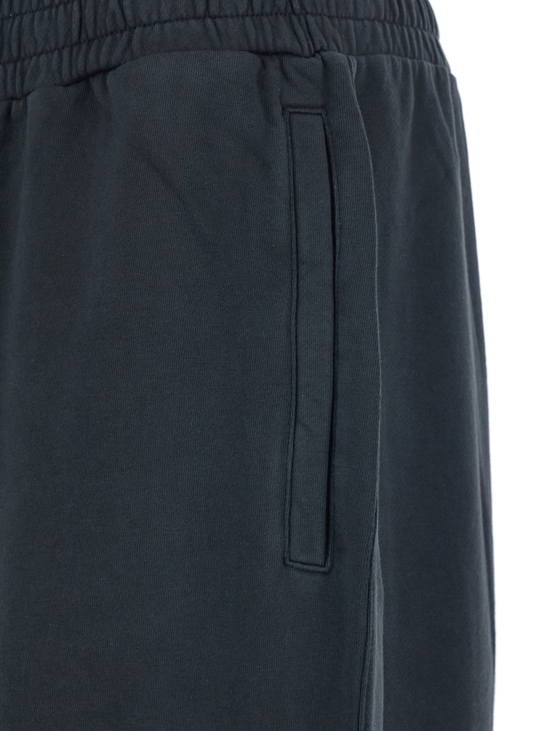 black pants with elastic waist and drawstring hem by Selfnex