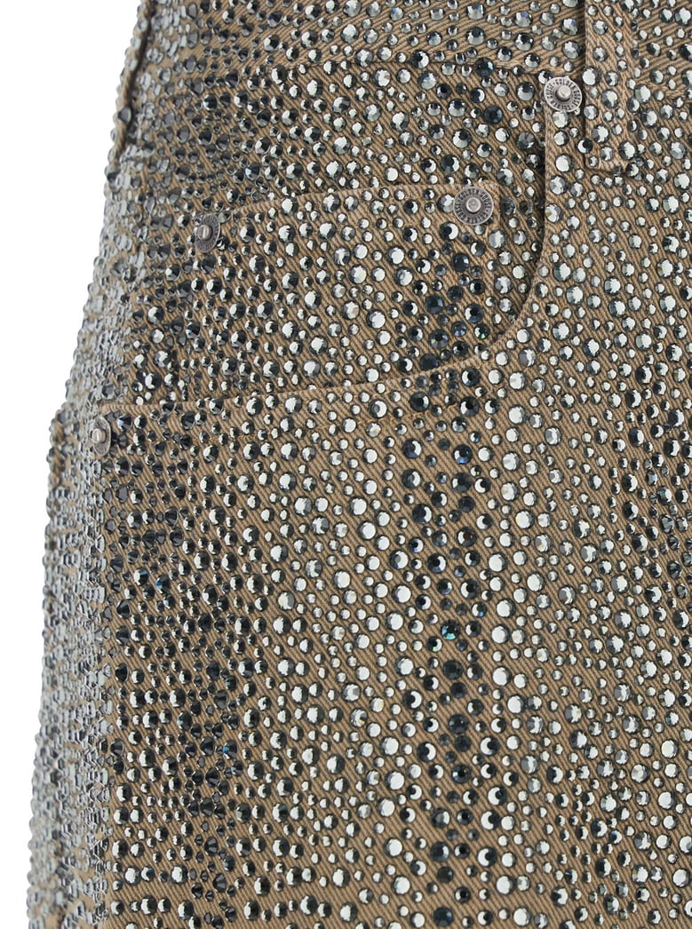 beige pants with crystal embellishment by Selfnex