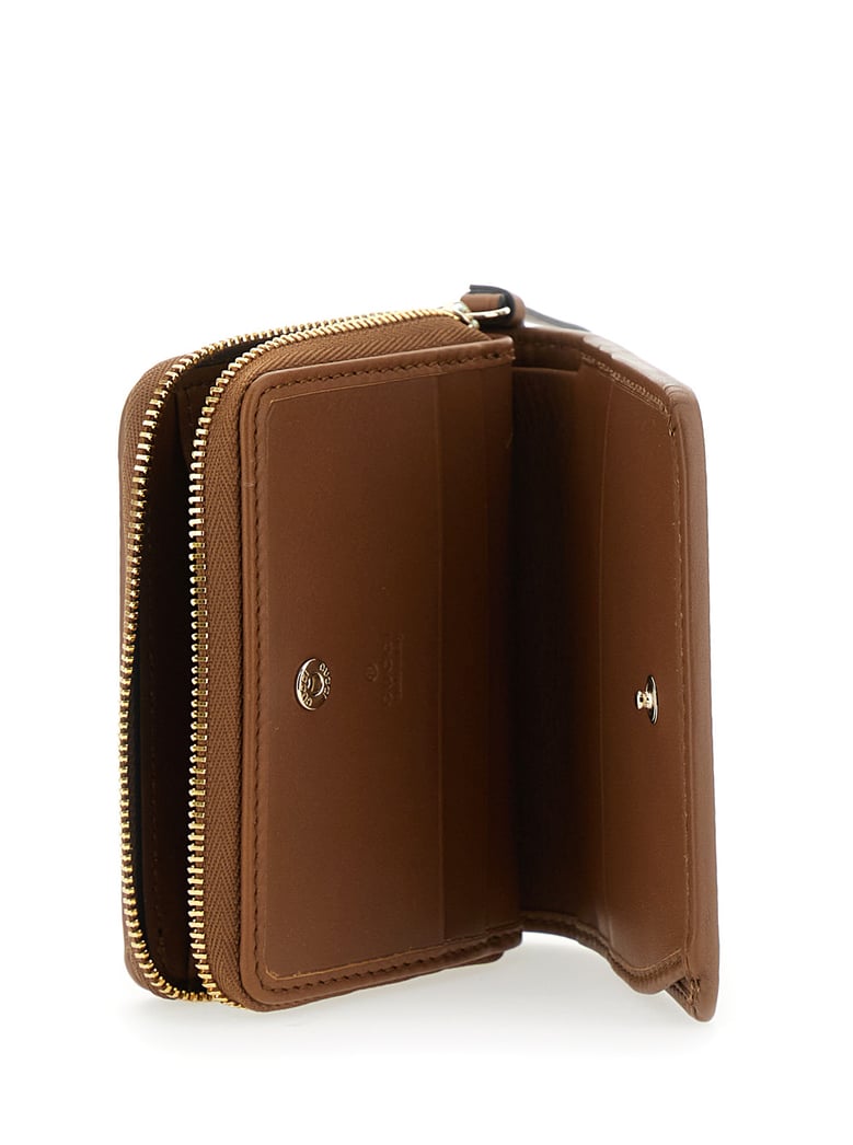 beige wallet with snap button and zip closure by Selfnex