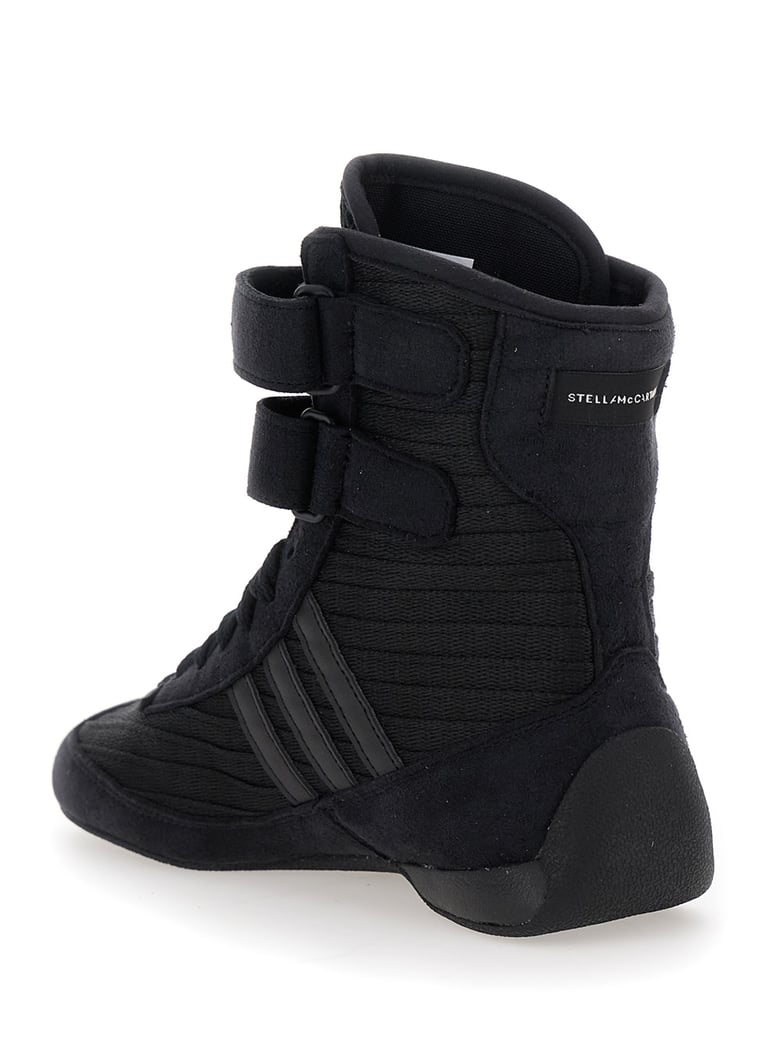 black sneakers with strap closure and logo detail by Selfnex
