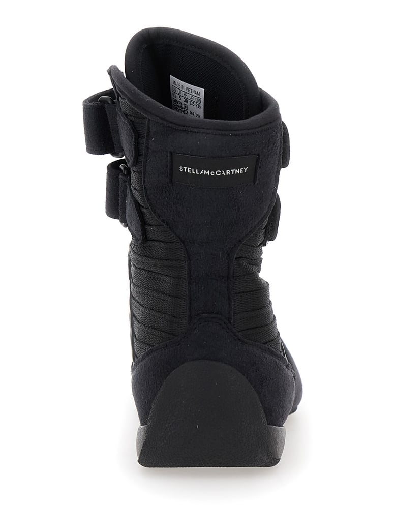 black sneakers with strap closure and logo detail by Selfnex