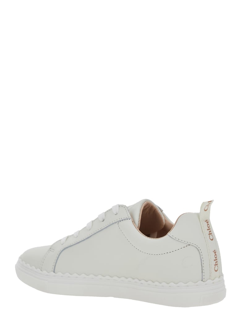 white low top sneakers with embossed logo by Selfnex