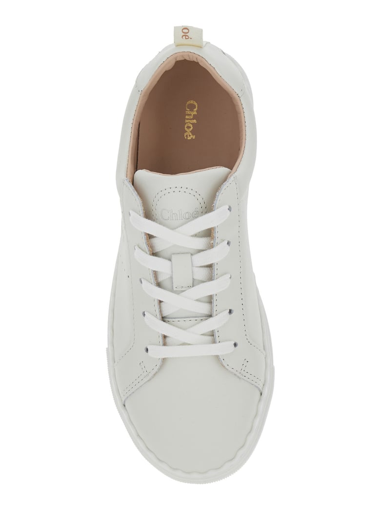 white low top sneakers with embossed logo by Selfnex