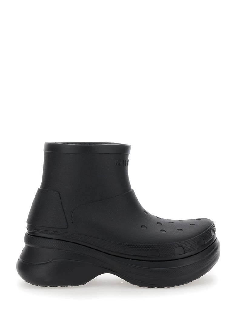 black ankle boots with embossed logo by Selfnex