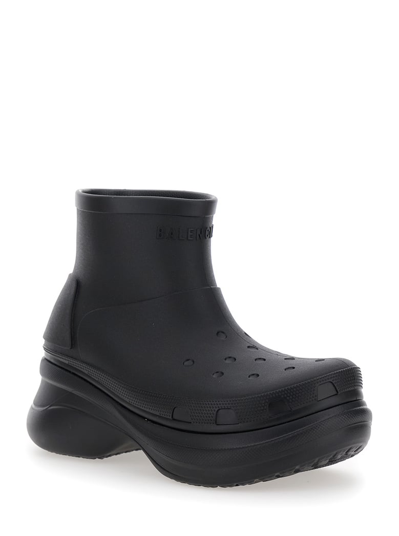 black ankle boots with embossed logo by Selfnex