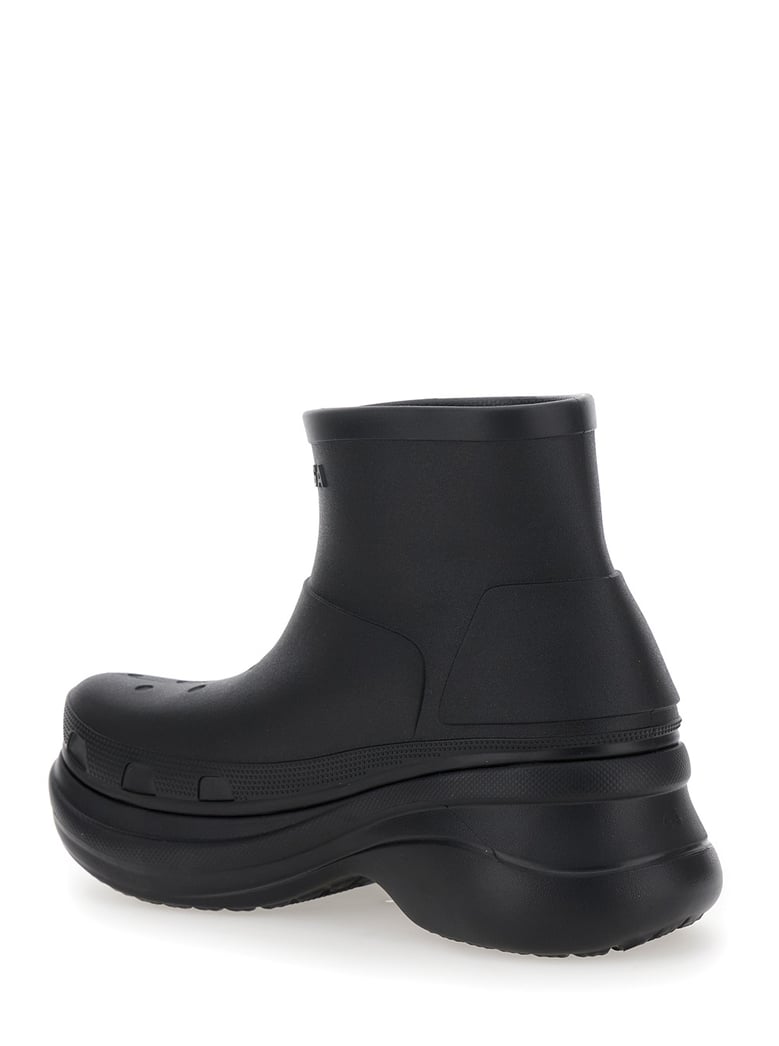 black ankle boots with embossed logo by Selfnex