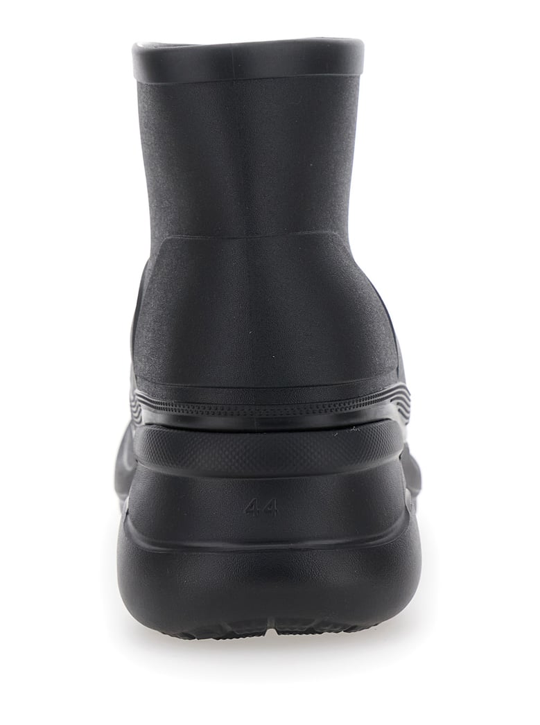 black ankle boots with embossed logo by Selfnex