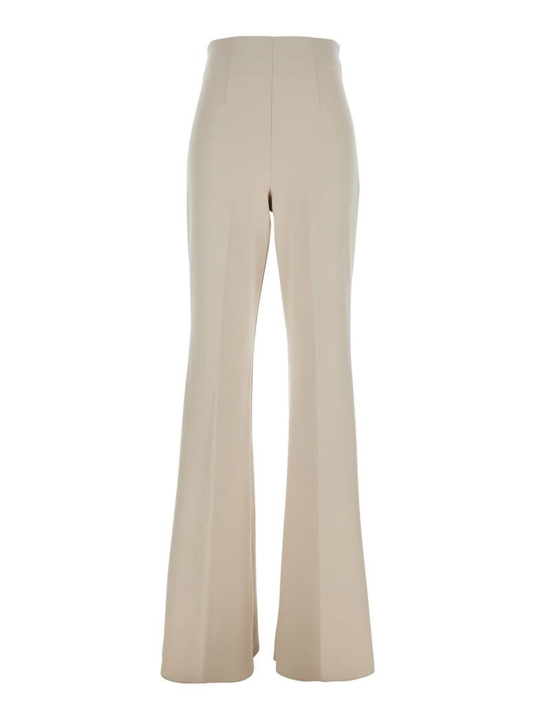 beige flared pants in tech fabric by Selfnex