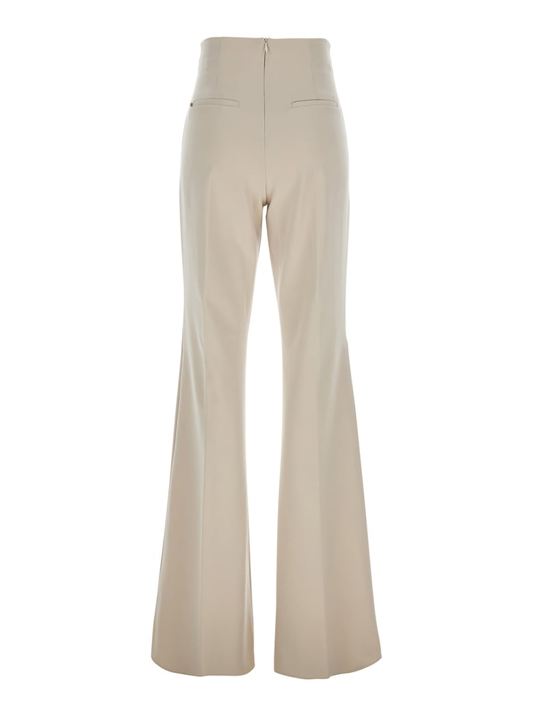 beige flared pants in tech fabric by Selfnex