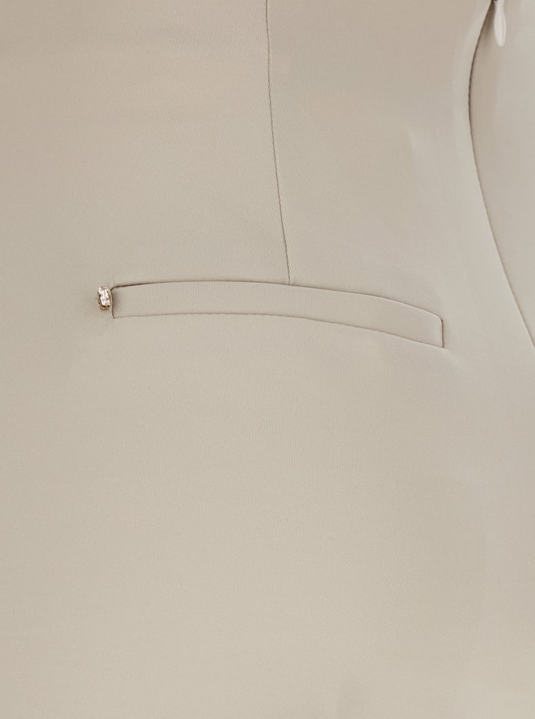 beige flared pants in tech fabric by Selfnex