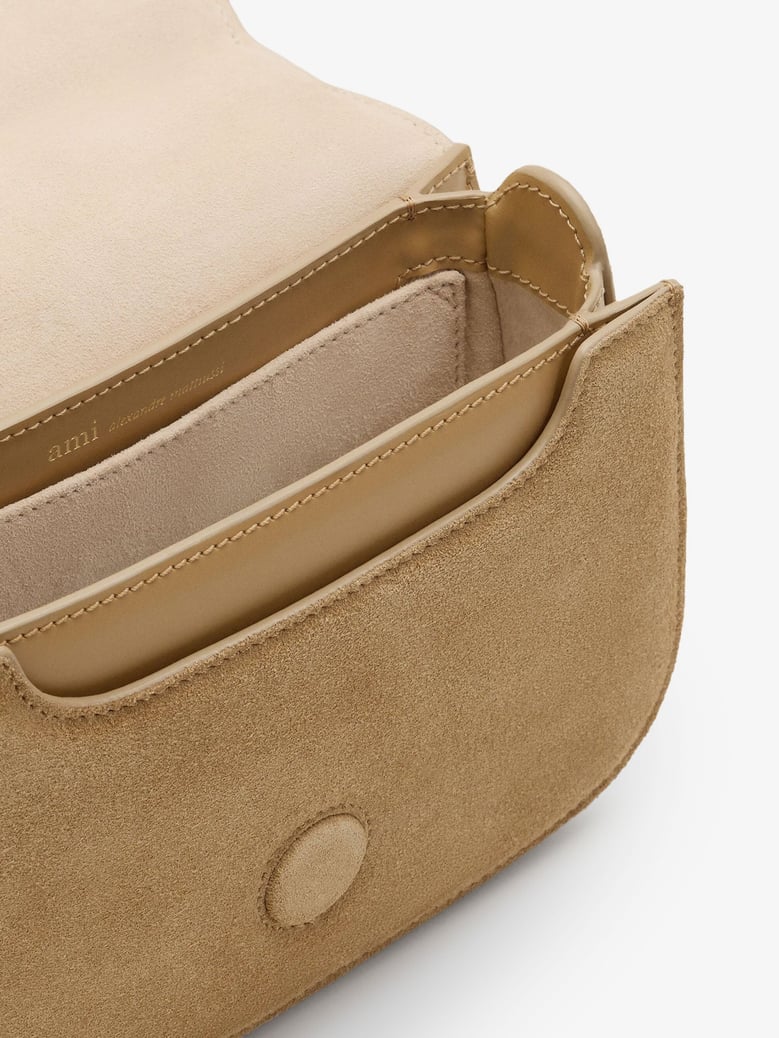 suede crossbody bag with metal logo by Selfnex